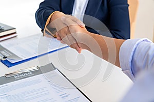 Good deal. Close-up of beautiful women business people shaking hands whileÂ successfulÂ job interview or Job applicant in modern